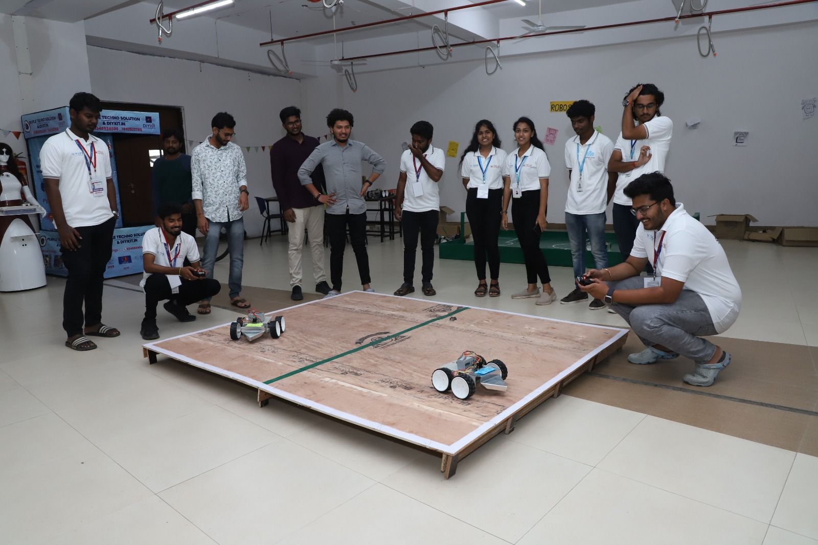Students demonstrating robots on a competition arena